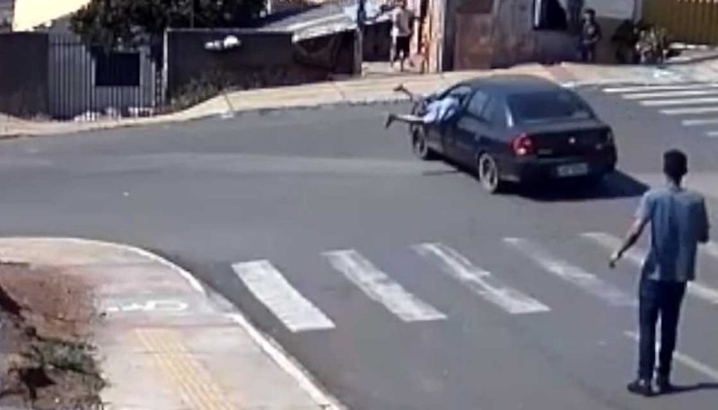 CCTV captures man jumping in window of moving car to stop crash