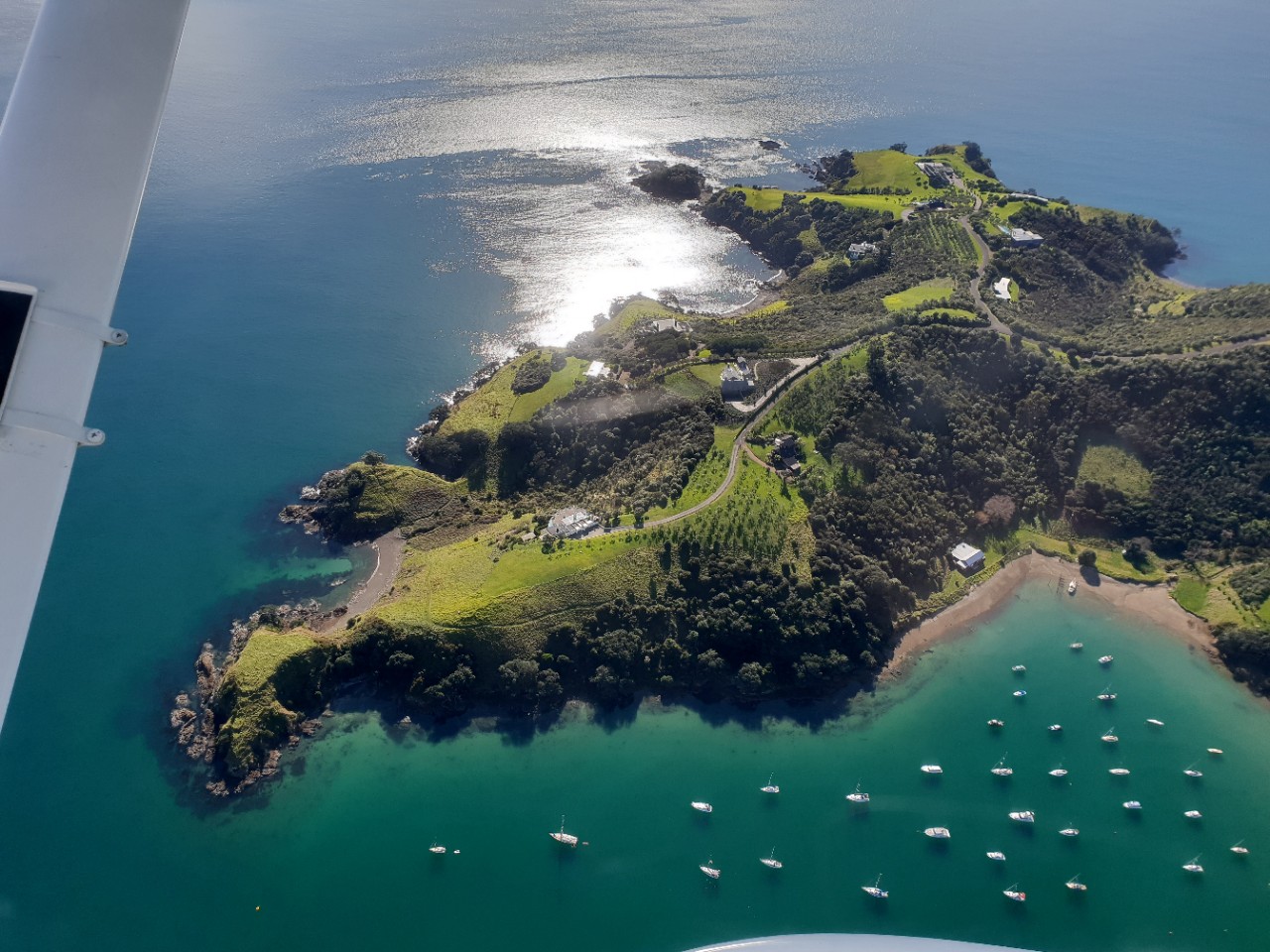 Auckland's Waiheke Island bay with moored yachts & boats from the air